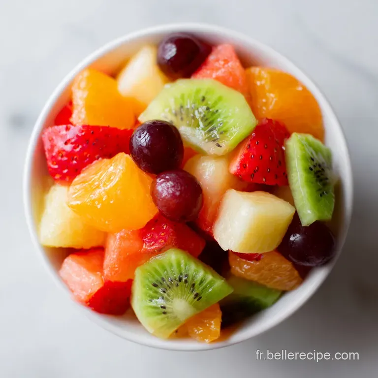 Elegant fruit salad plated with precision. Slices of star fruit, delicate raspberries, and a sprig of mint add a touch of ...